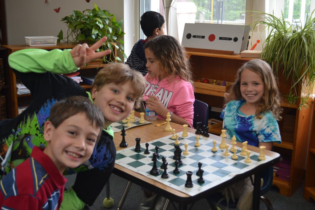 four children playing chess